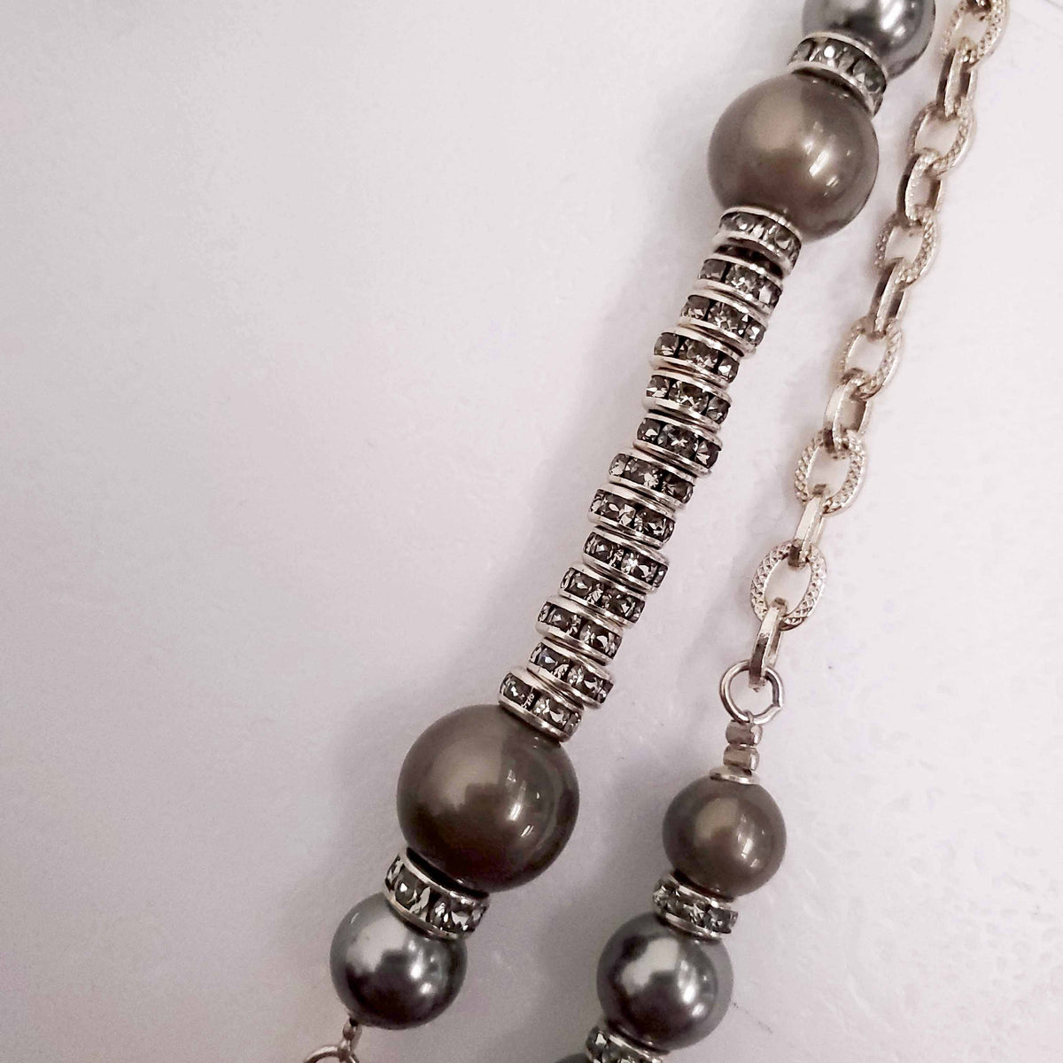 CHANEL GOLD, BRONZE, AND GREY LAYERED PEARL NECKLACE WITH CRYSTAL LOGOS